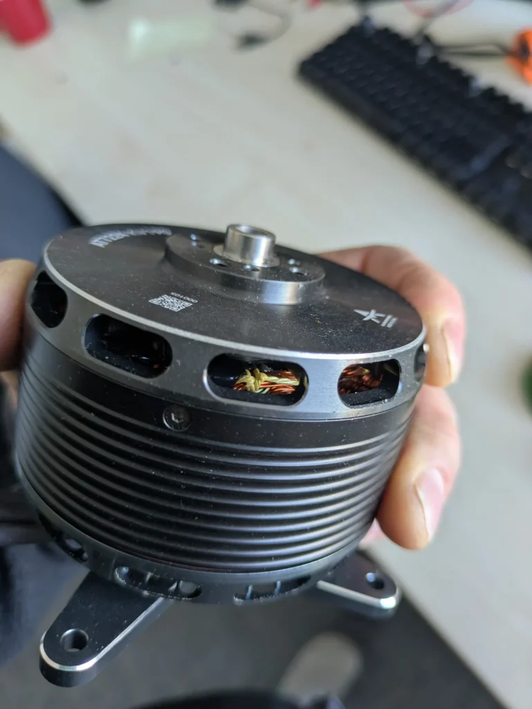 Outrunner motor with cooling fins held in a hand