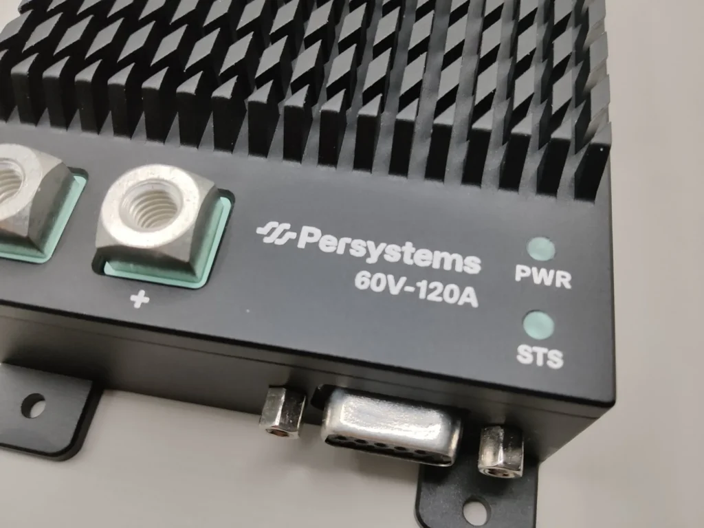 Connection side of the INV-60V-120A inverter: DC terminal, Persystems logo, status LEDs PWR and STS, D-sub connector